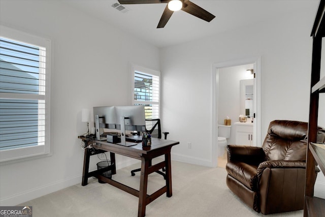 office space featuring light colored carpet and ceiling fan