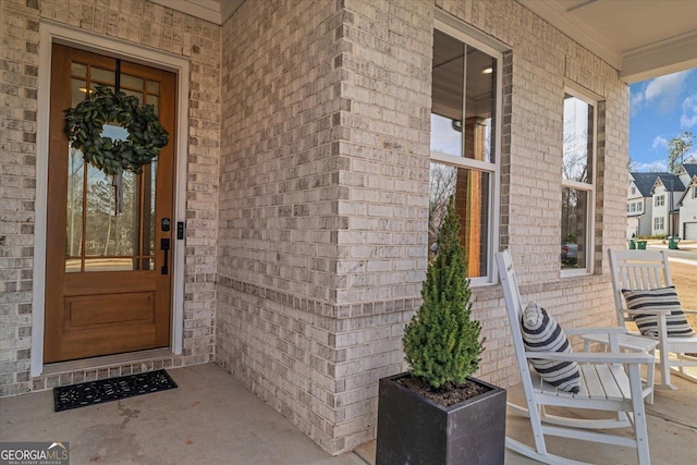 view of exterior entry with a porch