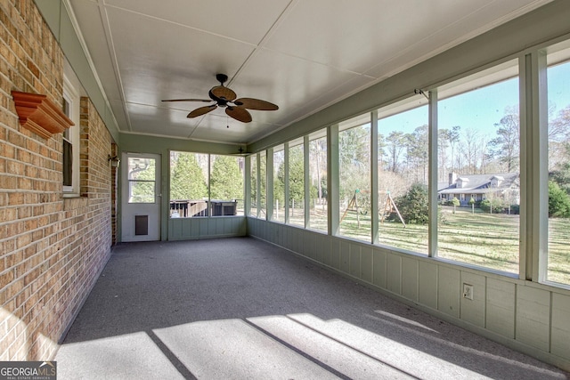 unfurnished sunroom featuring plenty of natural light and ceiling fan