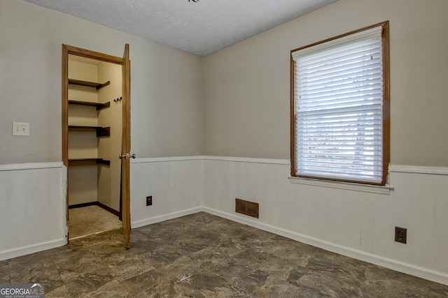 empty room with a textured ceiling