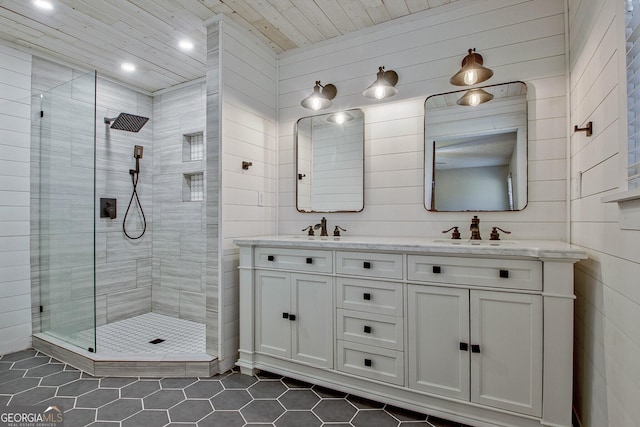 bathroom with vanity, an enclosed shower, and tile patterned floors