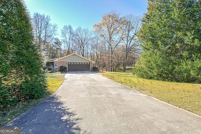 view of home's exterior with a garage and a lawn