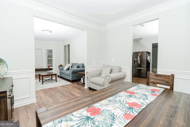 living room featuring crown molding and light wood-type flooring