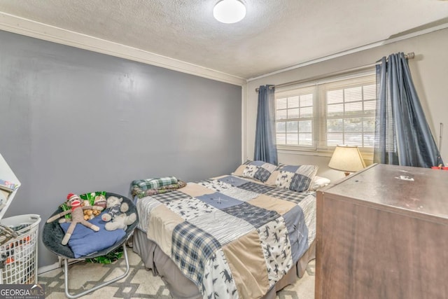 bedroom featuring ornamental molding and a textured ceiling