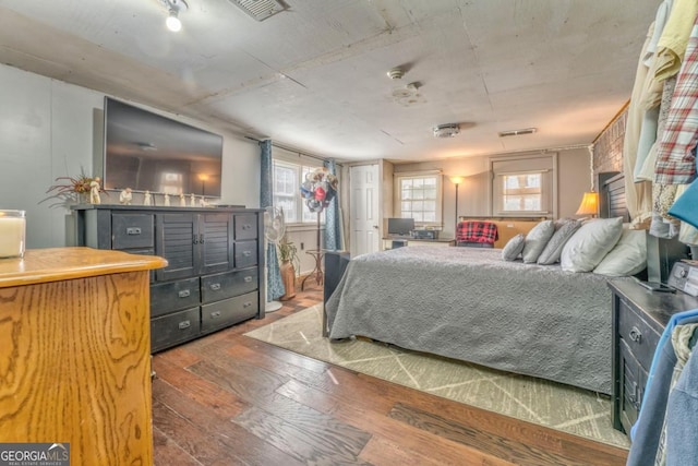 bedroom with dark wood-type flooring