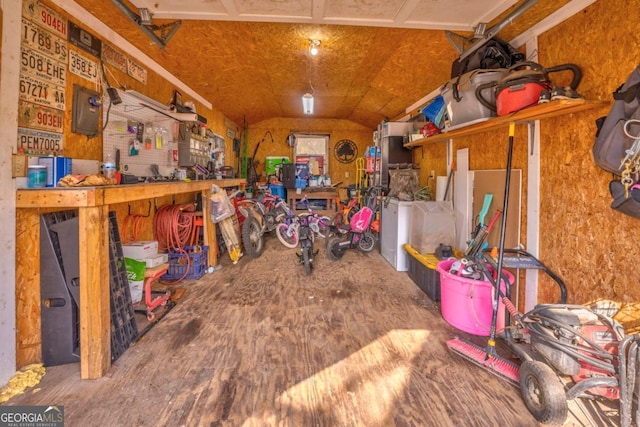 interior space with vaulted ceiling and a workshop area