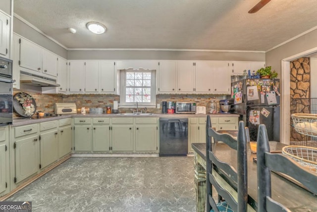 kitchen featuring sink, crown molding, tasteful backsplash, green cabinets, and black appliances