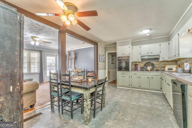 kitchen featuring sink, white cabinetry, ornamental molding, black appliances, and decorative backsplash