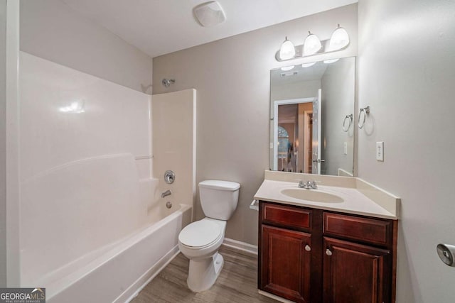 full bathroom with shower / washtub combination, hardwood / wood-style floors, vanity, and toilet