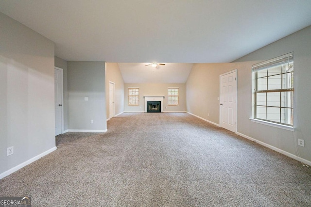 unfurnished living room featuring lofted ceiling and carpet