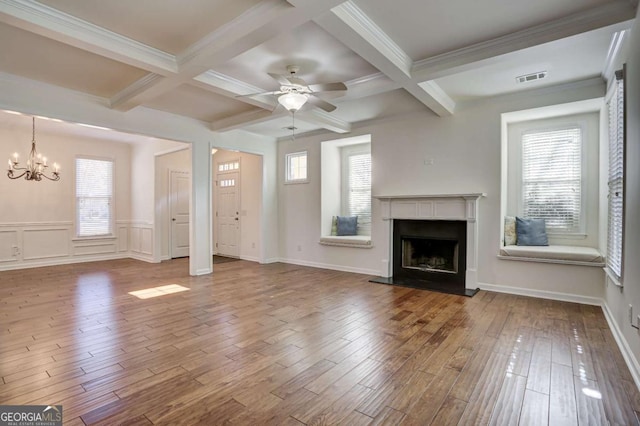 unfurnished living room featuring coffered ceiling, hardwood / wood-style flooring, and beamed ceiling