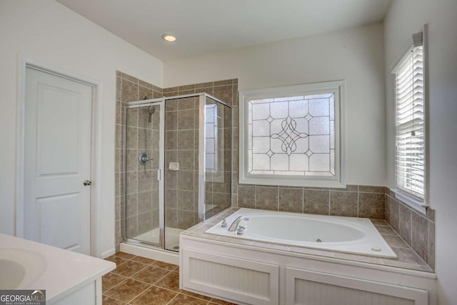 bathroom with vanity, plenty of natural light, tile patterned floors, and separate shower and tub