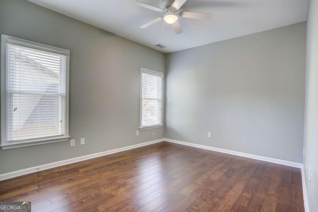 spare room with dark hardwood / wood-style floors and ceiling fan