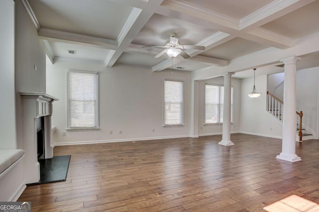 unfurnished living room featuring hardwood / wood-style floors, beam ceiling, ceiling fan, and ornate columns