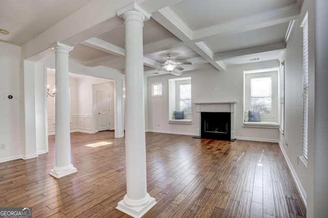 unfurnished living room with ceiling fan, wood-type flooring, beam ceiling, and decorative columns