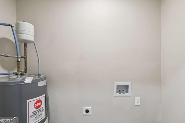 laundry area with hookup for an electric dryer, hookup for a washing machine, and water heater