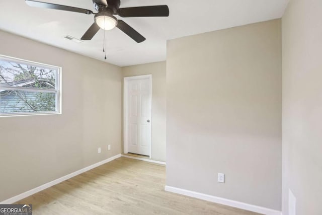 spare room with light hardwood / wood-style flooring and ceiling fan