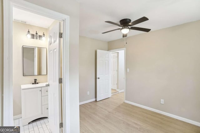 interior space featuring hardwood / wood-style flooring, ceiling fan, and vanity