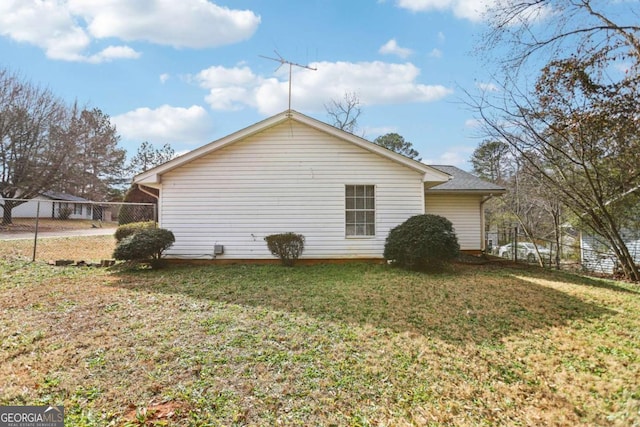 view of home's exterior with a yard