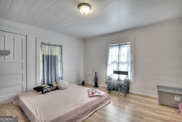 bedroom featuring wood ceiling and light hardwood / wood-style flooring