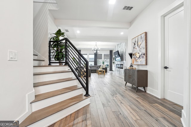 foyer entrance featuring recessed lighting, stairway, a chandelier, wood-type flooring, and visible vents