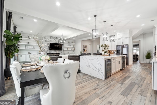kitchen featuring wine cooler, recessed lighting, visible vents, and a chandelier