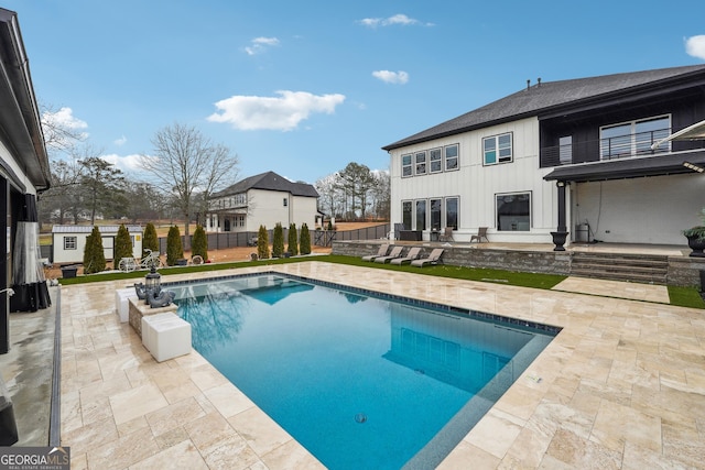 view of swimming pool with fence, a fenced in pool, and a patio area