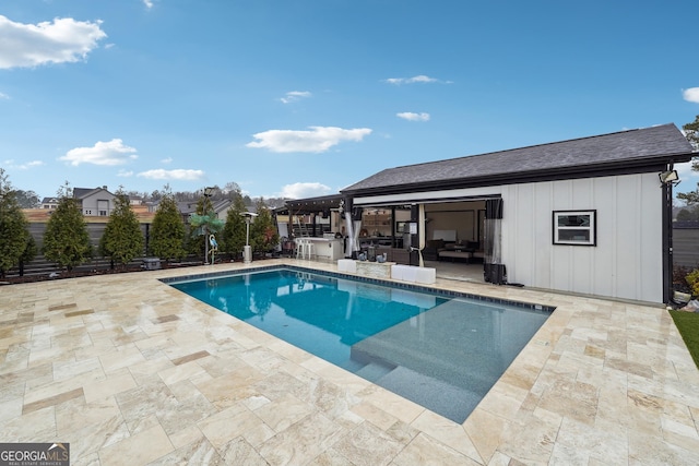 pool with a patio and an outdoor kitchen