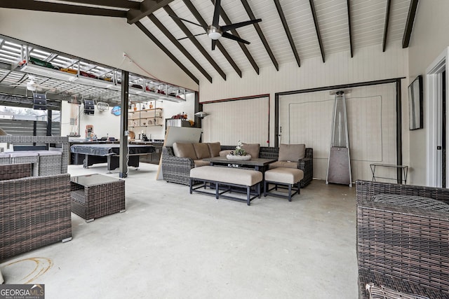 living area featuring beam ceiling, ceiling fan, high vaulted ceiling, and concrete flooring