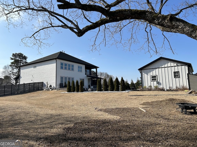 exterior space featuring board and batten siding and fence