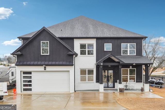 view of front of house featuring board and batten siding, driveway, an attached garage, and roof with shingles