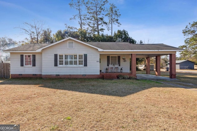 ranch-style house featuring a front lawn, a carport, and covered porch