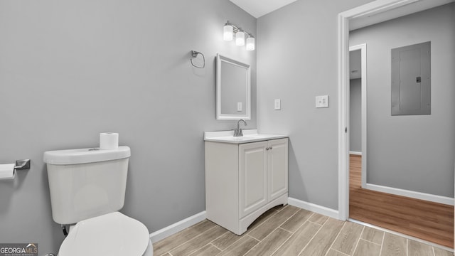 bathroom with vanity, electric panel, and toilet