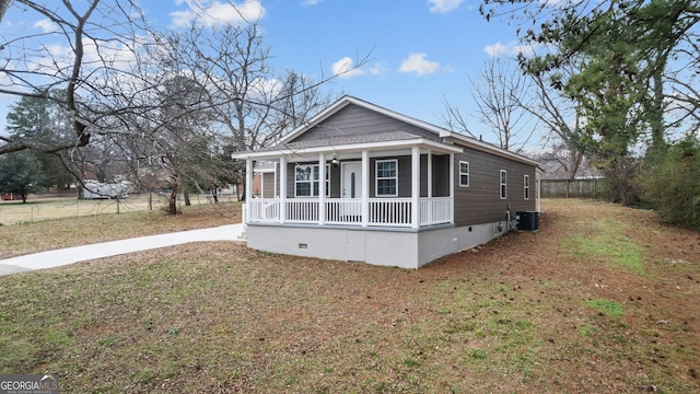 view of front of property with a porch, central AC unit, and a front lawn