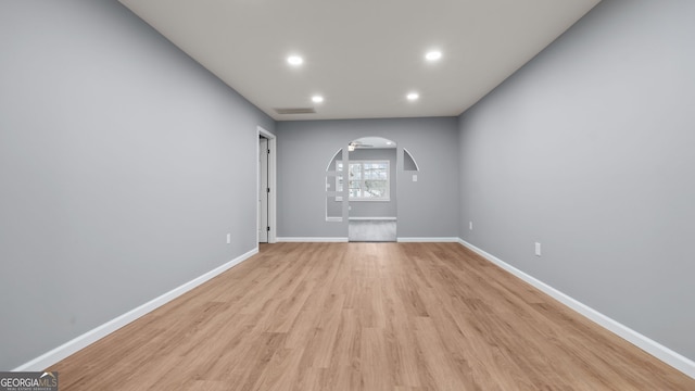 unfurnished room with light wood-type flooring