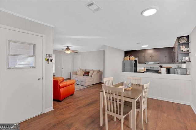 dining area featuring dark hardwood / wood-style flooring and ceiling fan