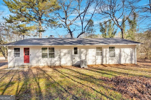 rear view of property with a lawn