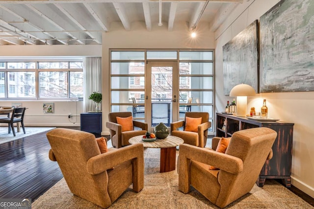 sitting room with hardwood / wood-style flooring, beam ceiling, and french doors