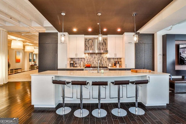 kitchen featuring a spacious island, white cabinetry, and pendant lighting