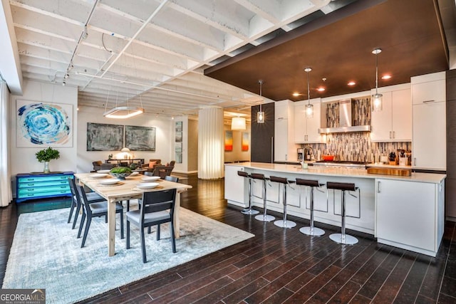 dining space featuring sink and dark hardwood / wood-style flooring