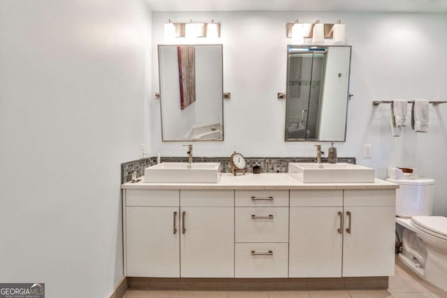 bathroom with vanity, toilet, and tile patterned flooring