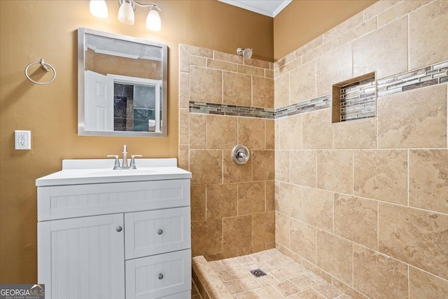 bathroom with vanity and tiled shower