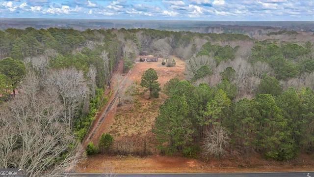 birds eye view of property with a forest view