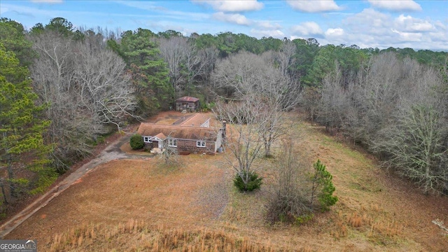 drone / aerial view featuring a wooded view