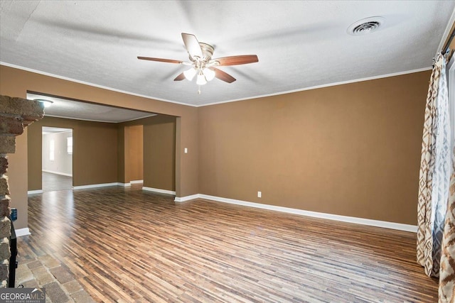 spare room featuring hardwood / wood-style flooring, crown molding, ceiling fan, and a textured ceiling