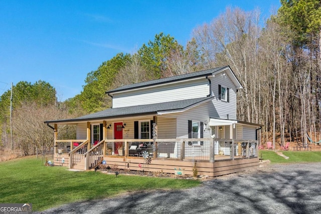 view of front of home with a porch and a front yard