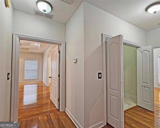 corridor with hardwood / wood-style flooring