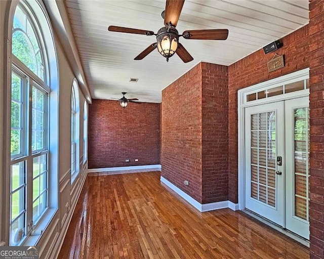 unfurnished sunroom featuring french doors and ceiling fan