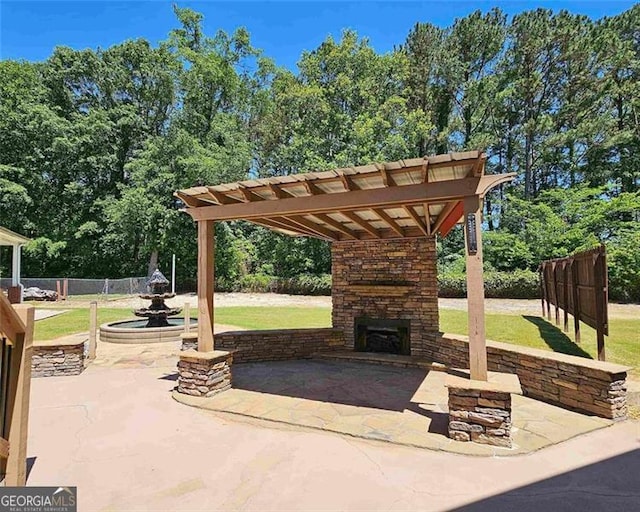 view of patio / terrace with an outdoor stone fireplace