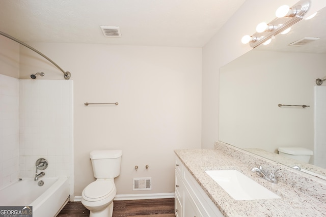 full bathroom featuring vanity, wood-type flooring, bathtub / shower combination, and toilet